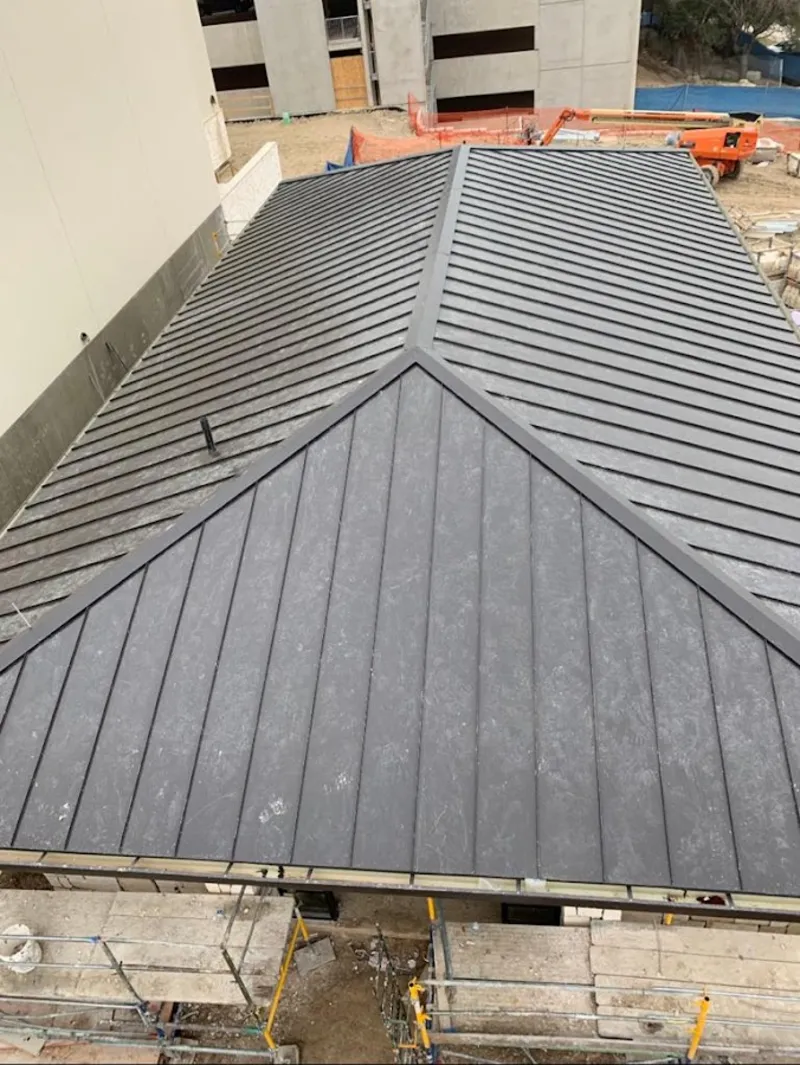 Commercial metal roof construction with crane equipment in Fairfield